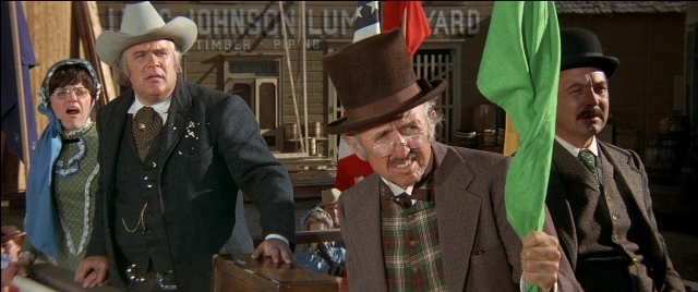 Wide shot frame from Blazing Saddles — standing, hat, suit