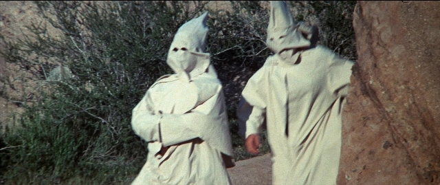 Wide shot frame from Blazing Saddles — standing, walking, hat