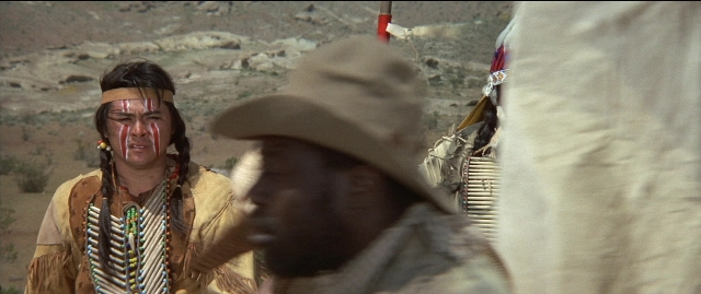 Wide shot frame from Blazing Saddles — standing, hat, face