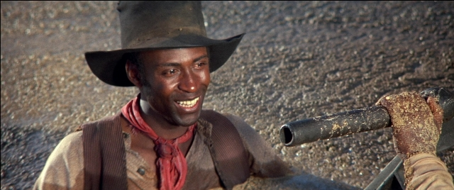 Wide shot frame from Blazing Saddles — street, hat, hand