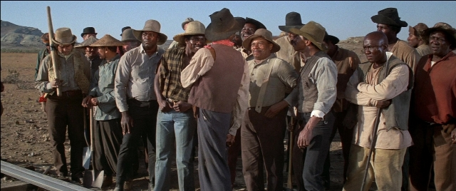 Wide shot frame from Blazing Saddles — standing, street, person