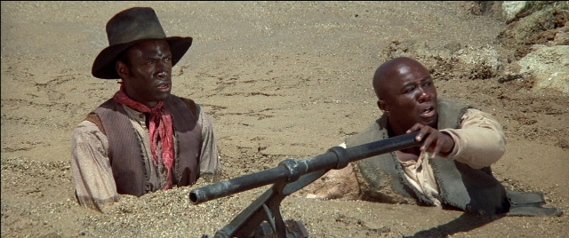 Wide shot frame from Blazing Saddles — sitting, hat, face