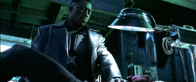 Wide shot frame from Blade — room, bed, face