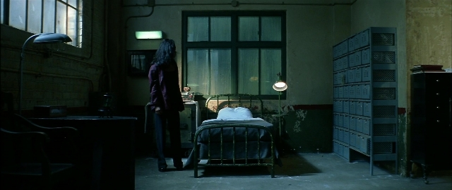 Wide shot frame from Blade — standing, room, table