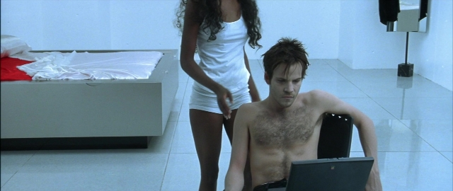 Wide shot frame from Blade — sitting, standing, room