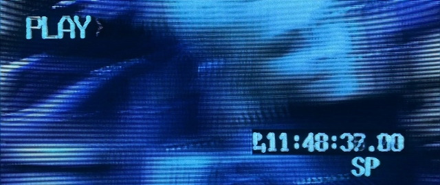 Frame from Blade — face, clock, person