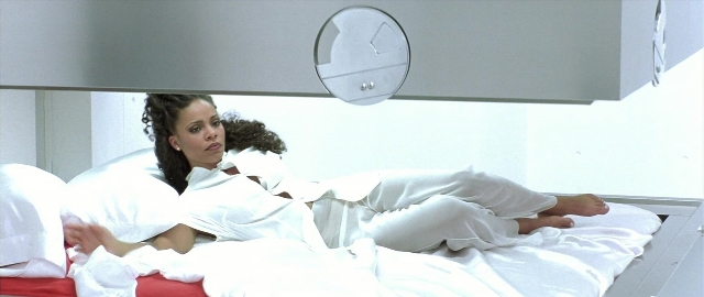 Wide shot frame from Blade — bed, dress, bedroom