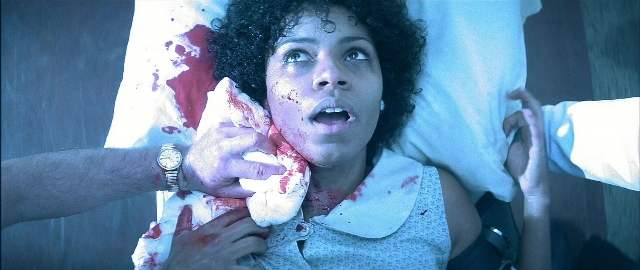 Medium shot frame from Blade — bed, hand, face