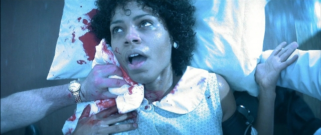 Medium shot frame from Blade — room, bed, hand