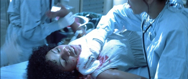 Wide shot frame from Blade — standing, bed, uniform