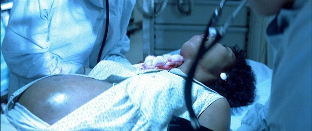 Wide shot frame from Blade — standing, room, bed