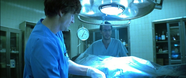 Wide shot frame from Blade — room, bed, clock