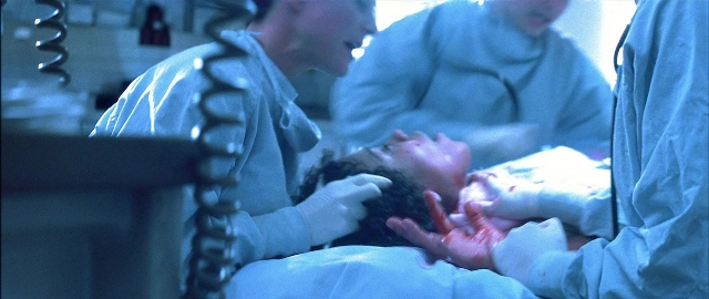 Wide shot frame from Blade — standing, room, bed