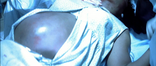 Wide shot frame from Blade — bed, dress, bedroom