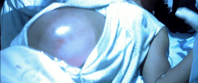 Wide shot frame from Blade — bed, person