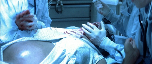 Wide shot frame from Blade — room, bed, person