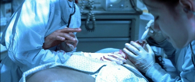 Wide shot frame from Blade — standing, room, bed
