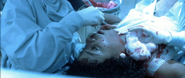 Wide shot frame from Blade — room, bed, face