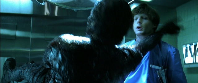 Wide shot frame from Blade — standing, dialogue, coat