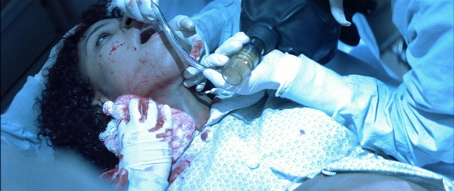 Wide shot frame from Blade — bed, face, person