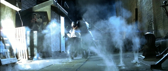 Wide shot frame from Blade — night, smoke, fountain