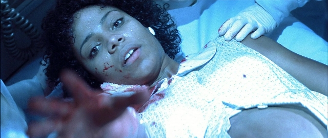 Wide shot frame from Blade — bed, face, person