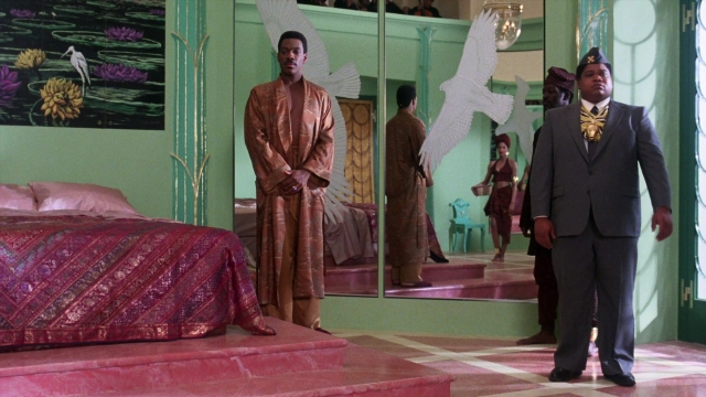Wide shot frame from Coming to America — standing, room, dialogue
