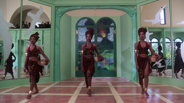 Wide shot frame from Coming to America — walking, room, bird