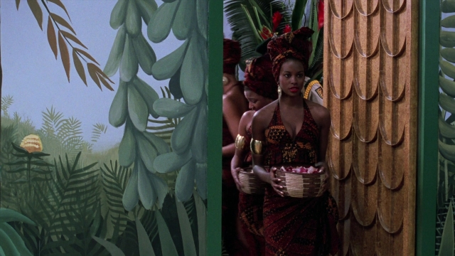 Wide shot frame from Coming to America — standing, dress, bird
