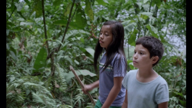 Wide shot frame from Noche de Fuego — standing, shirt, face