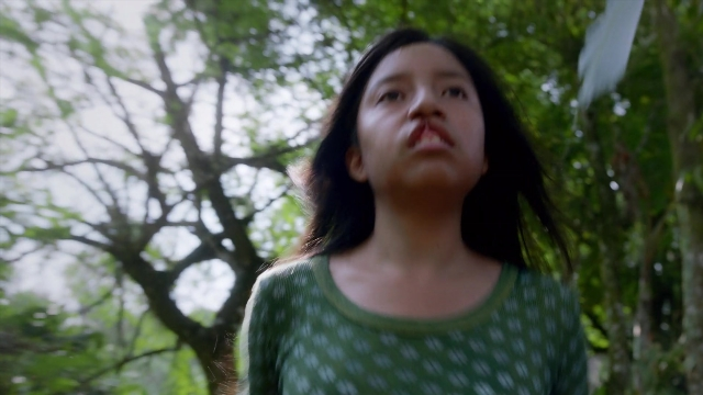 Medium shot frame from Noche de Fuego — shirt, face, hair