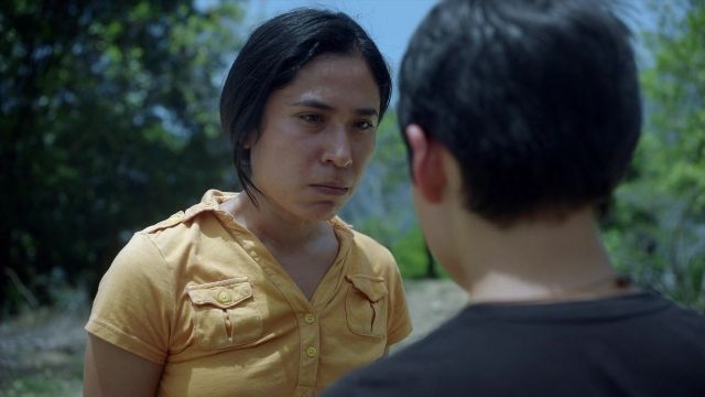 Medium shot frame from Noche de Fuego — standing, shirt, face