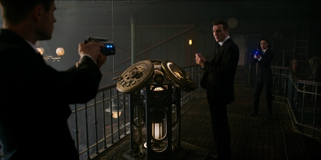 Wide shot frame from Men in Black International — standing, room, clock