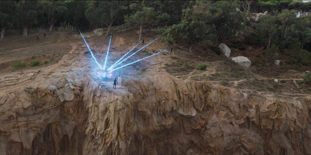 Wide shot frame from Men in Black International — standing, water, person