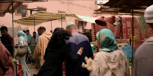 Wide shot frame from Men in Black International — walking, door, dog