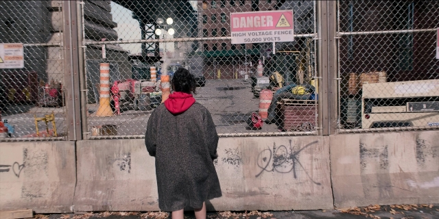 Wide shot frame from Men in Black International — standing, coat, person