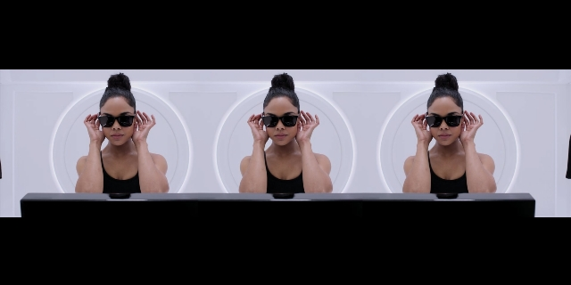 Wide shot frame from Men in Black International — sitting, table, hair