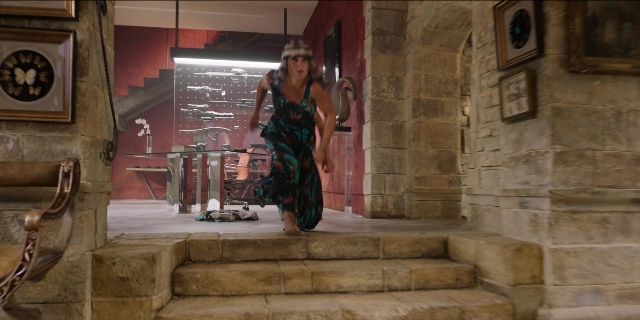 Wide shot frame from Men in Black International — walking, room, table