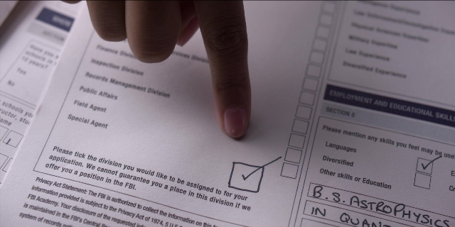 Wide shot frame from Men in Black International — hand, person, human hand
