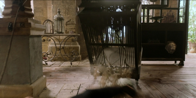 Wide shot frame from Men in Black International — room, hand, furniture