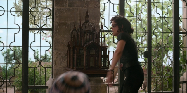 Wide shot frame from Men in Black International — standing, hand, bird