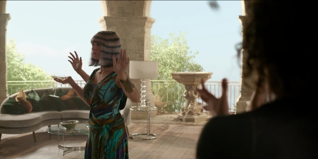 Frame from Men in Black International — sitting, standing, room