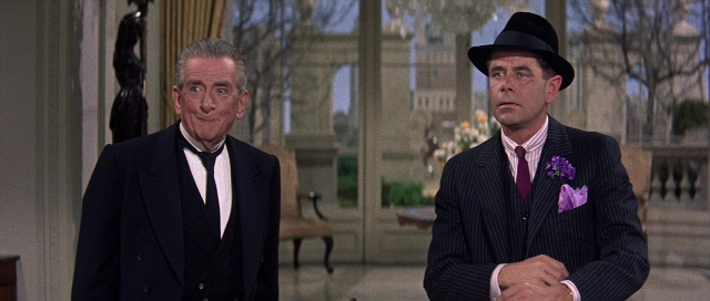 Wide shot frame from Pocketful of Miracles — standing, room, hat