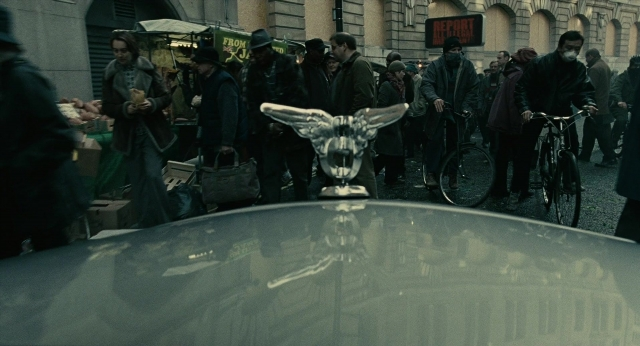 Wide shot frame from Children of Men — street, car, bicycle