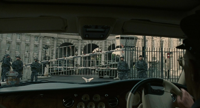 Wide shot frame from Children of Men — standing, street, car