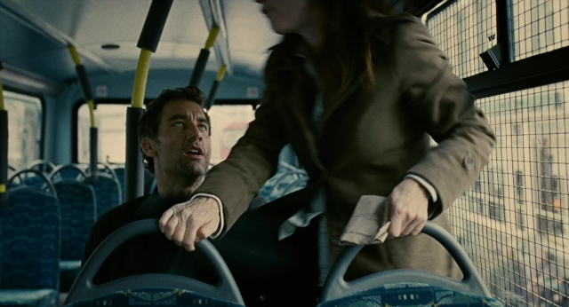 Wide shot frame from Children of Men — sitting, standing, car