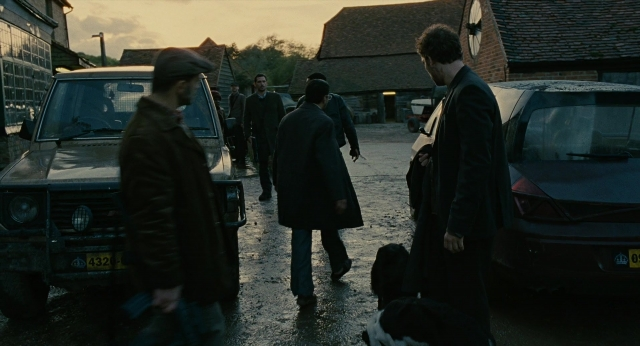 Wide shot frame from Children of Men — walking, street, dog