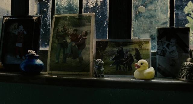 Wide shot frame from Children of Men — dog, duck, person