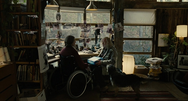 Wide shot frame from Children of Men — sitting, book, standing