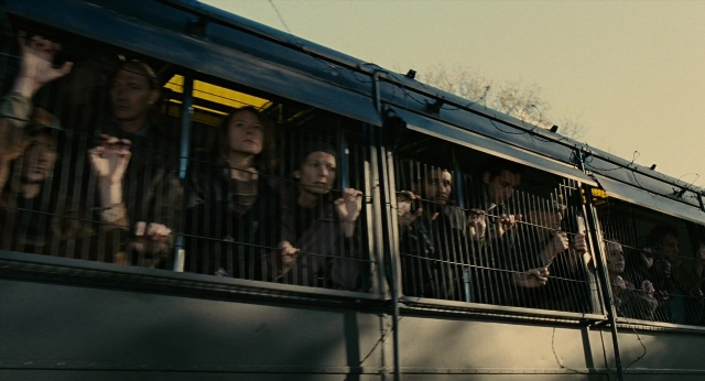 Wide shot frame from Children of Men — standing, bus, person